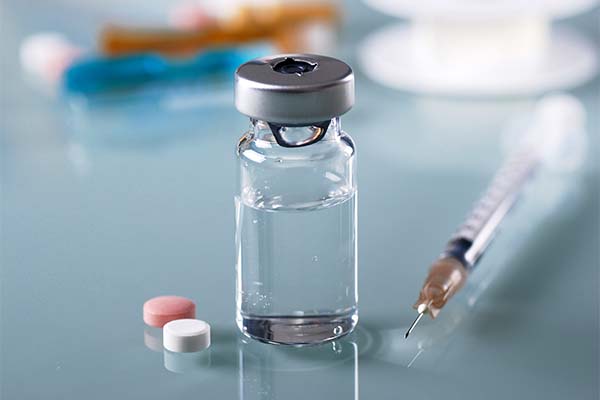 pills wrapped into a hundred dollar bill